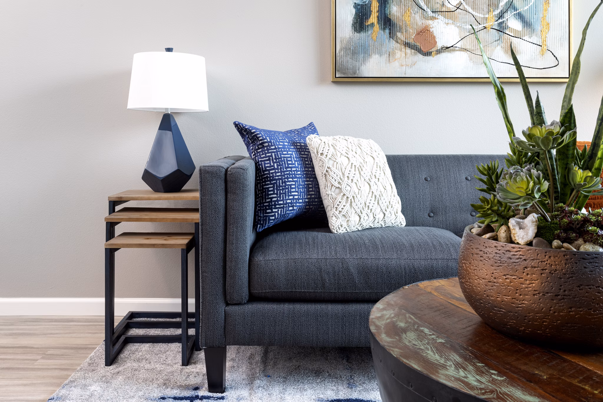 Living room featuring modern decor and large windows at 7403 Apartments, a Greystar community