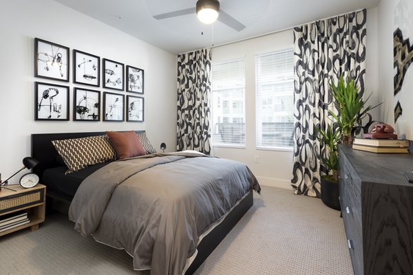 Cozy bedroom featuring plush bedding and modern decor at Jefferson Edge Apartments