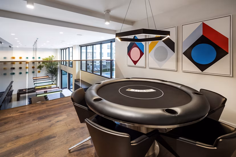 Game room with pool table and arcade games at Jefferson Edge Apartments, luxurious community space for entertainment and recreation