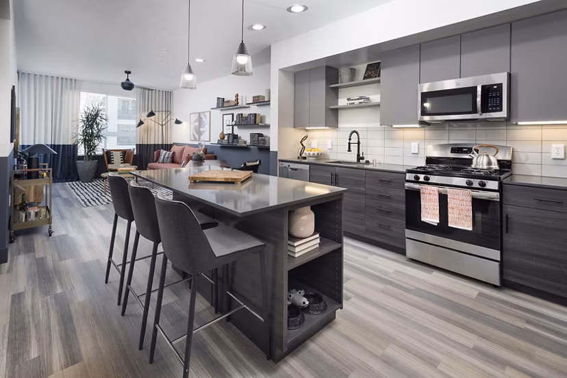 Modern kitchen with stainless steel appliances and granite countertops in Jefferson Edge Apartments