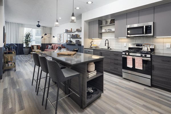 Modern kitchen with stainless steel appliances and granite countertops in Jefferson Edge Apartments