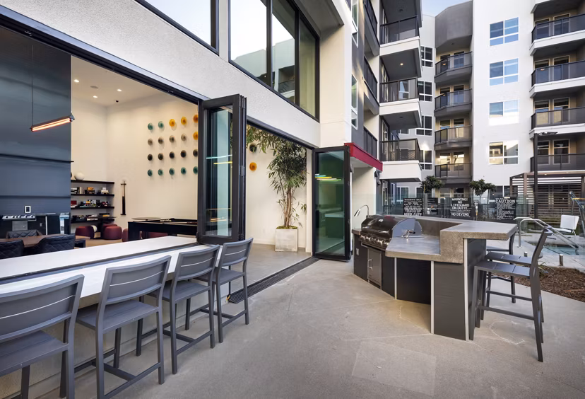 Outdoor grill area with modern barbecue stations at Jefferson Edge Apartments
