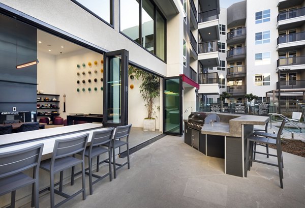 Outdoor grill area with modern barbecue stations at Jefferson Edge Apartments