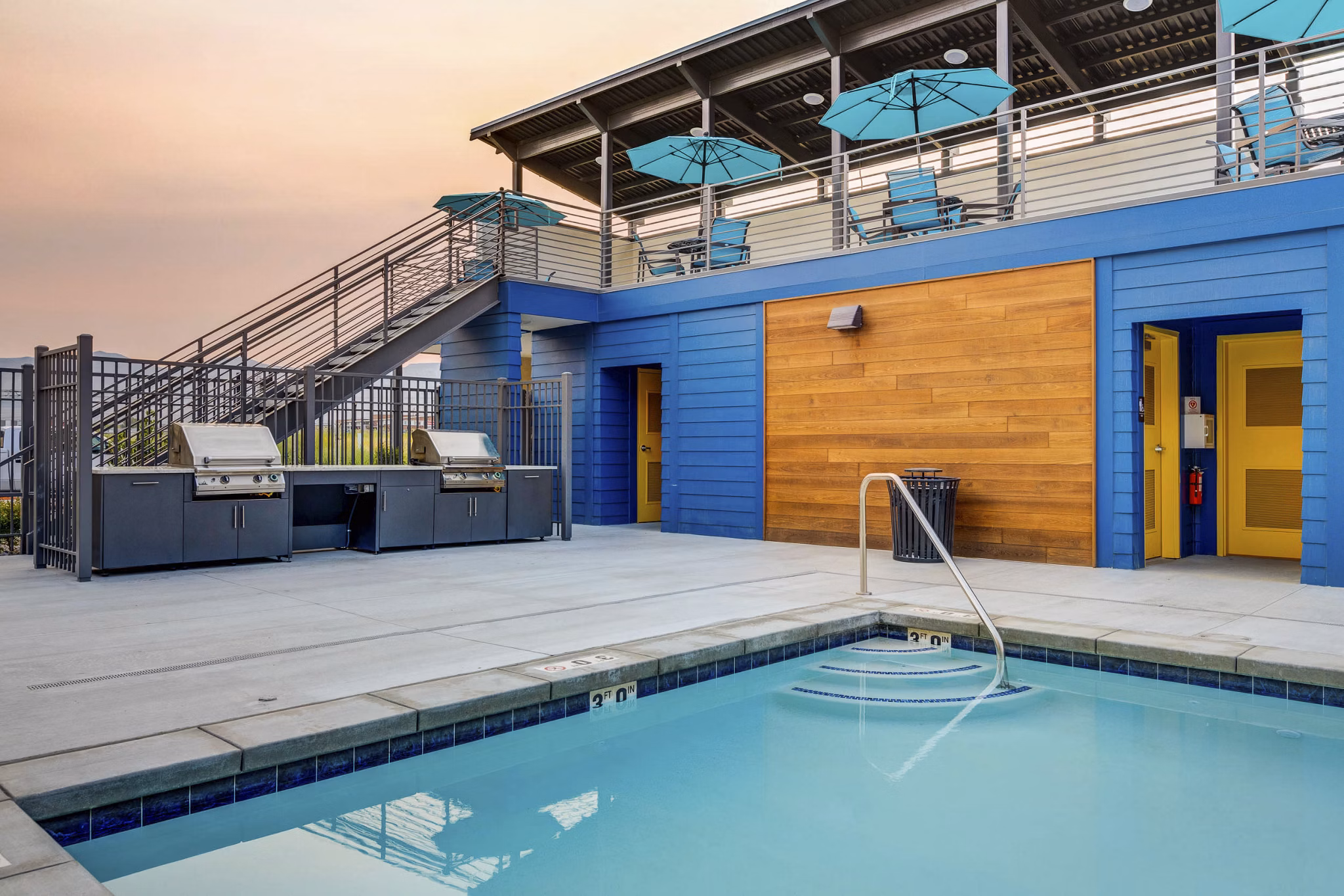 Resort-style pool at Vida at Daybreak Apartments featuring sun loungers and landscaped surroundings