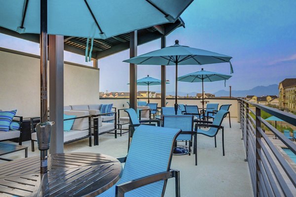 Cozy patio with outdoor seating at Vida at Daybreak Apartments, perfect for relaxation and social gatherings