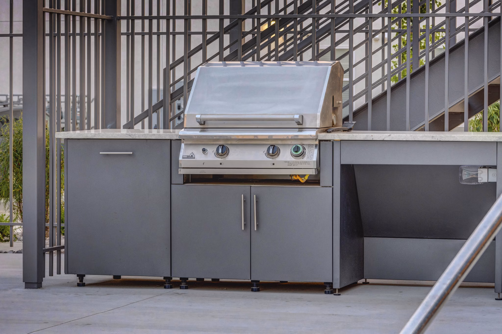 Outdoor dining area with grill at Vida at Daybreak Apartments, perfect for social gatherings