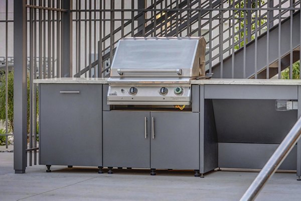 Outdoor dining area with grill at Vida at Daybreak Apartments, perfect for social gatherings