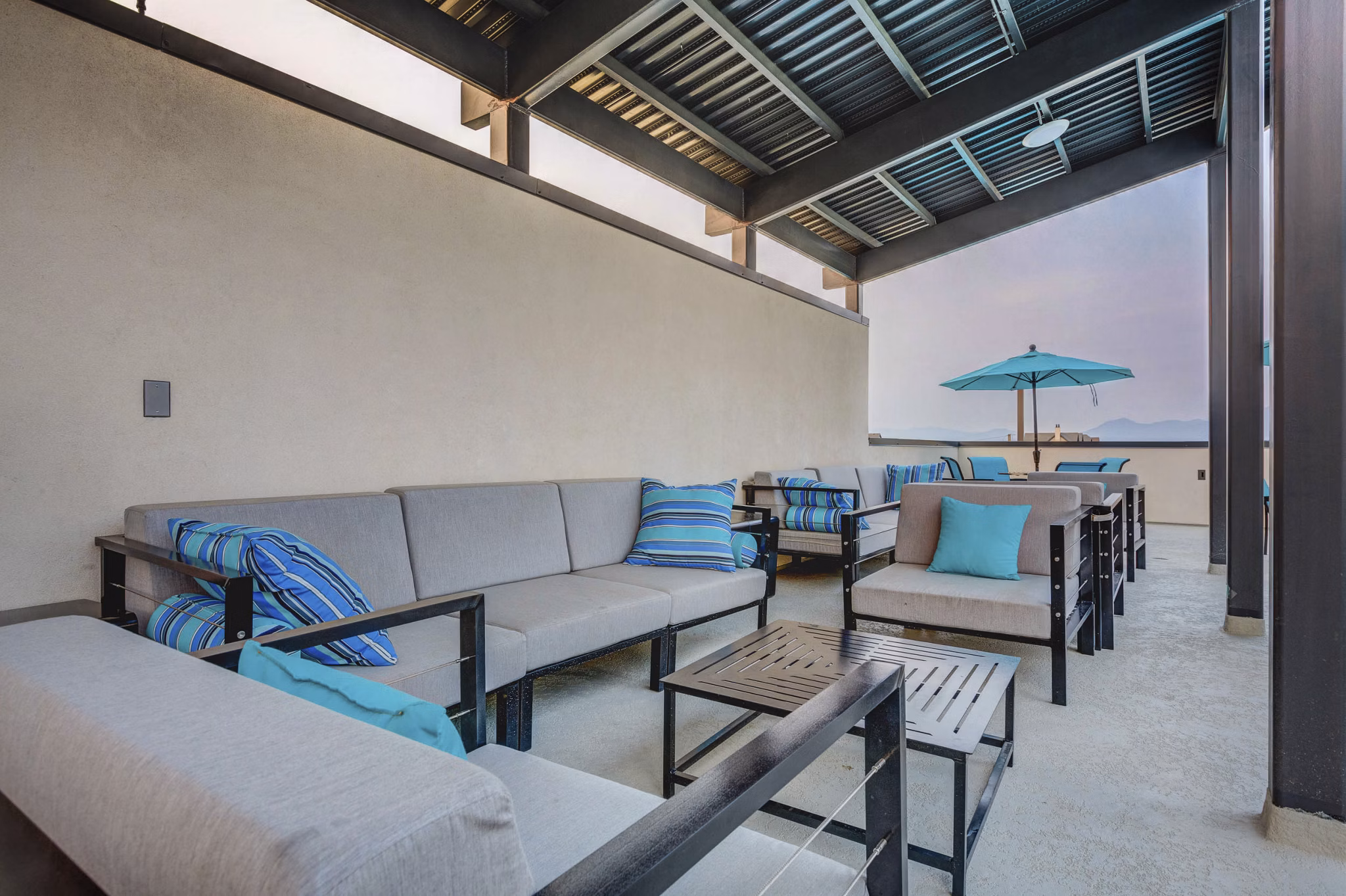 Modern patio with comfortable seating and landscaping at Vida at Daybreak Apartments