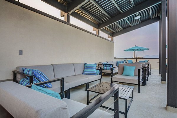 Modern patio with comfortable seating and landscaping at Vida at Daybreak Apartments