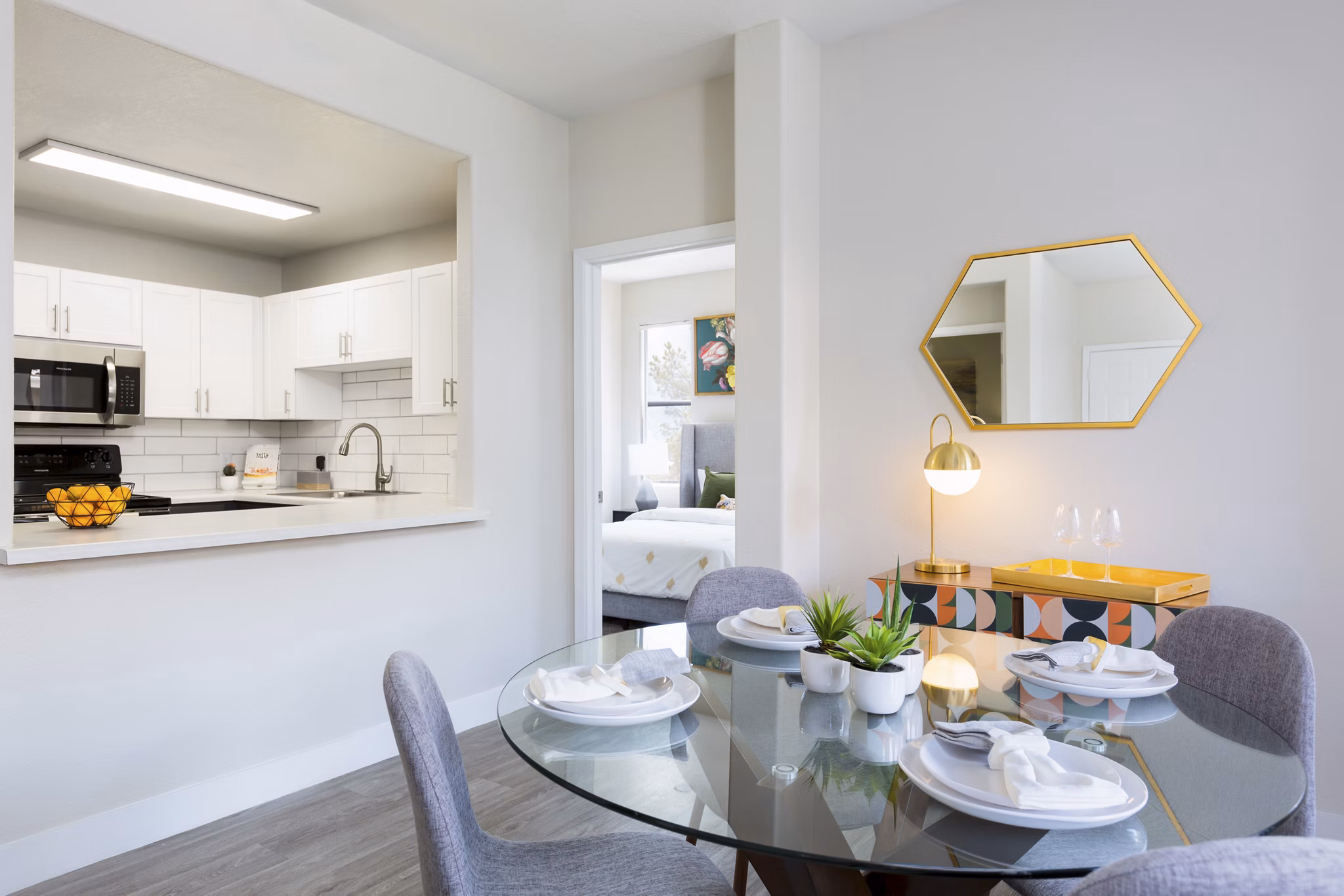 Dining room with stylish lighting and modern furniture at Morada West Apartments