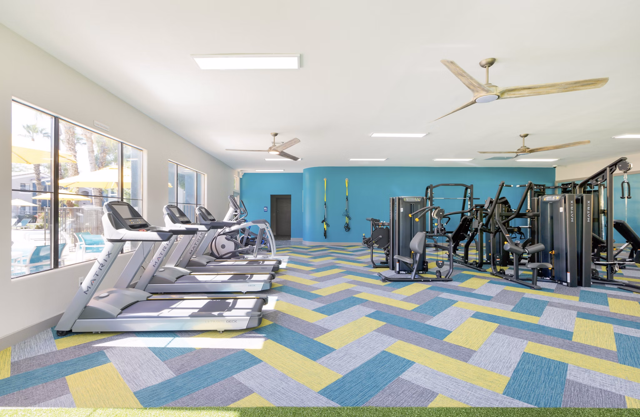 Fully-equipped fitness center featuring modern gym equipment at Morada West Apartments