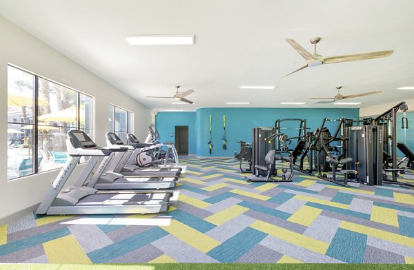 Fully-equipped fitness center featuring modern gym equipment at Morada West Apartments