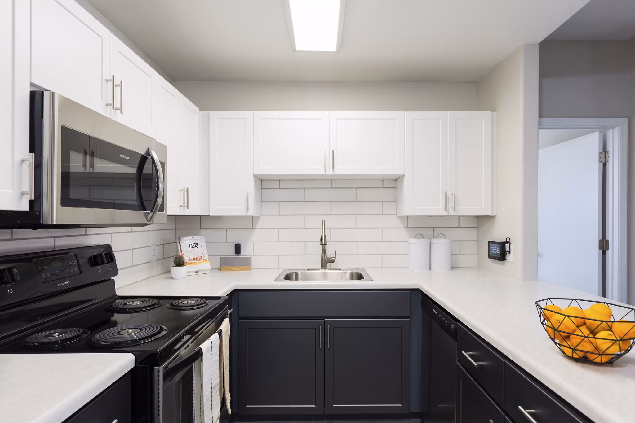 Modern kitchen with stainless steel appliances and granite countertops at Morada West Apartments Perfect blend of style and functionality