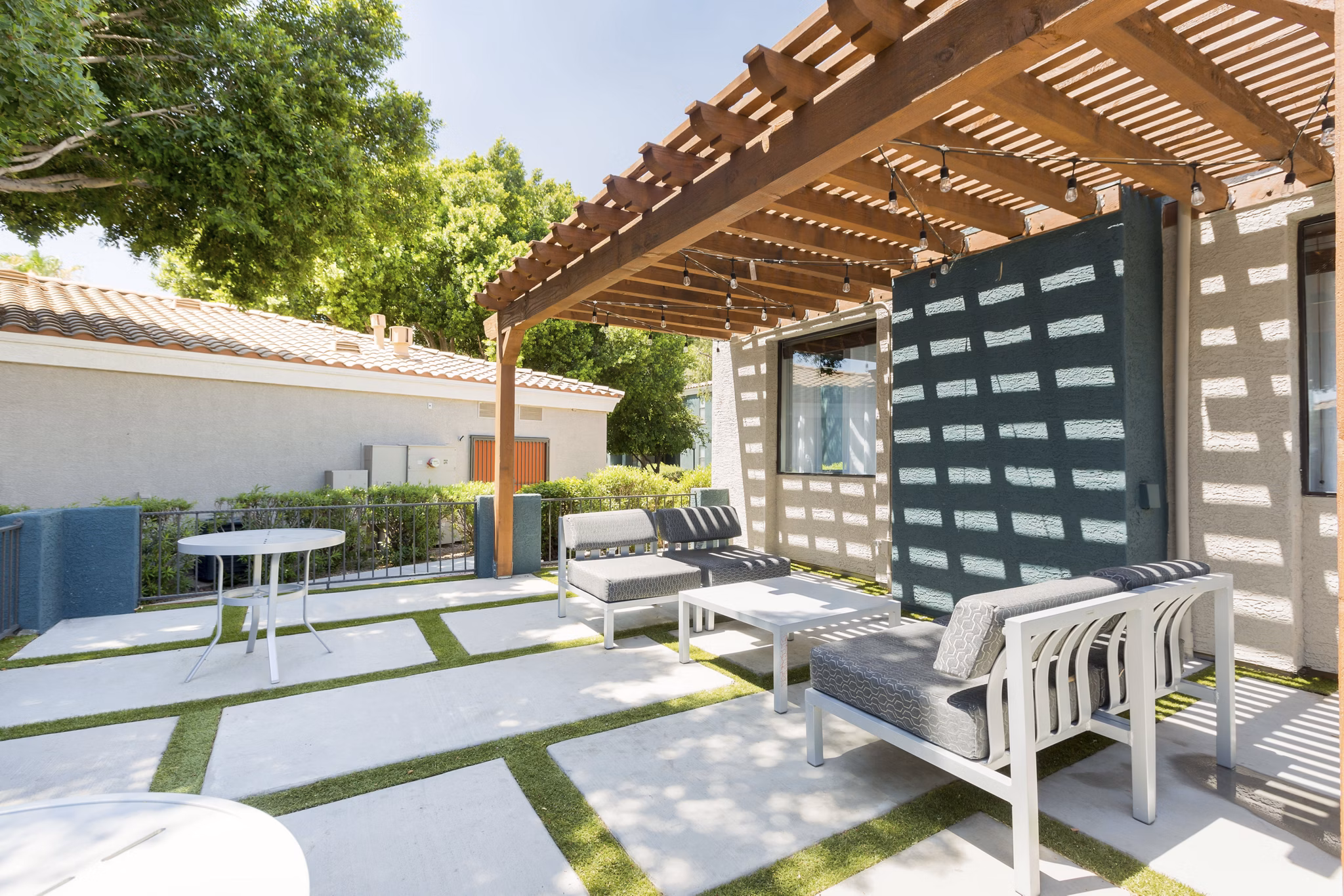 Patio with modern seating and garden view at Morada West Apartments, a Greystar luxury community in a vibrant neighborhood