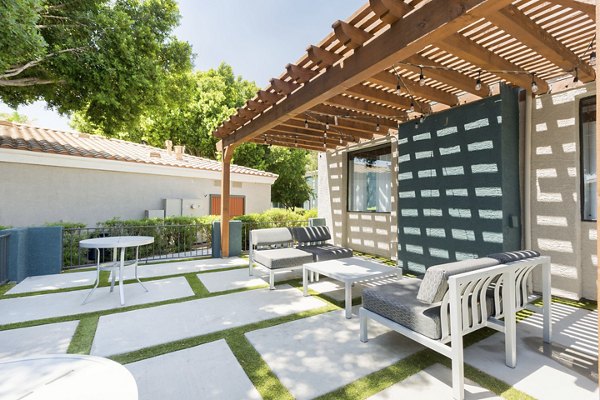 Patio with modern seating and garden view at Morada West Apartments, a Greystar luxury community in a vibrant neighborhood
