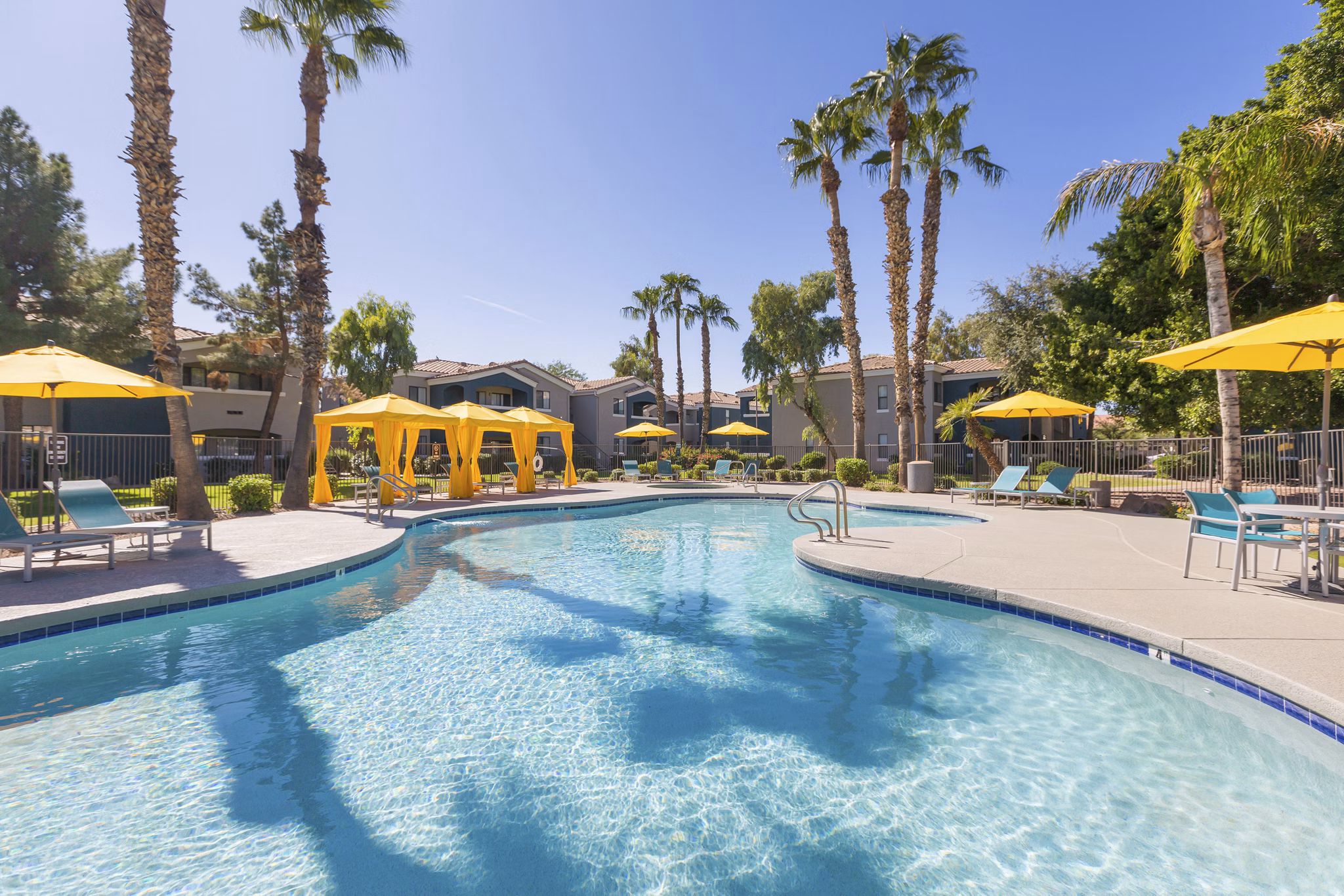 Modern pool with lounge chairs at Morada West Apartments, a luxury Greystar property