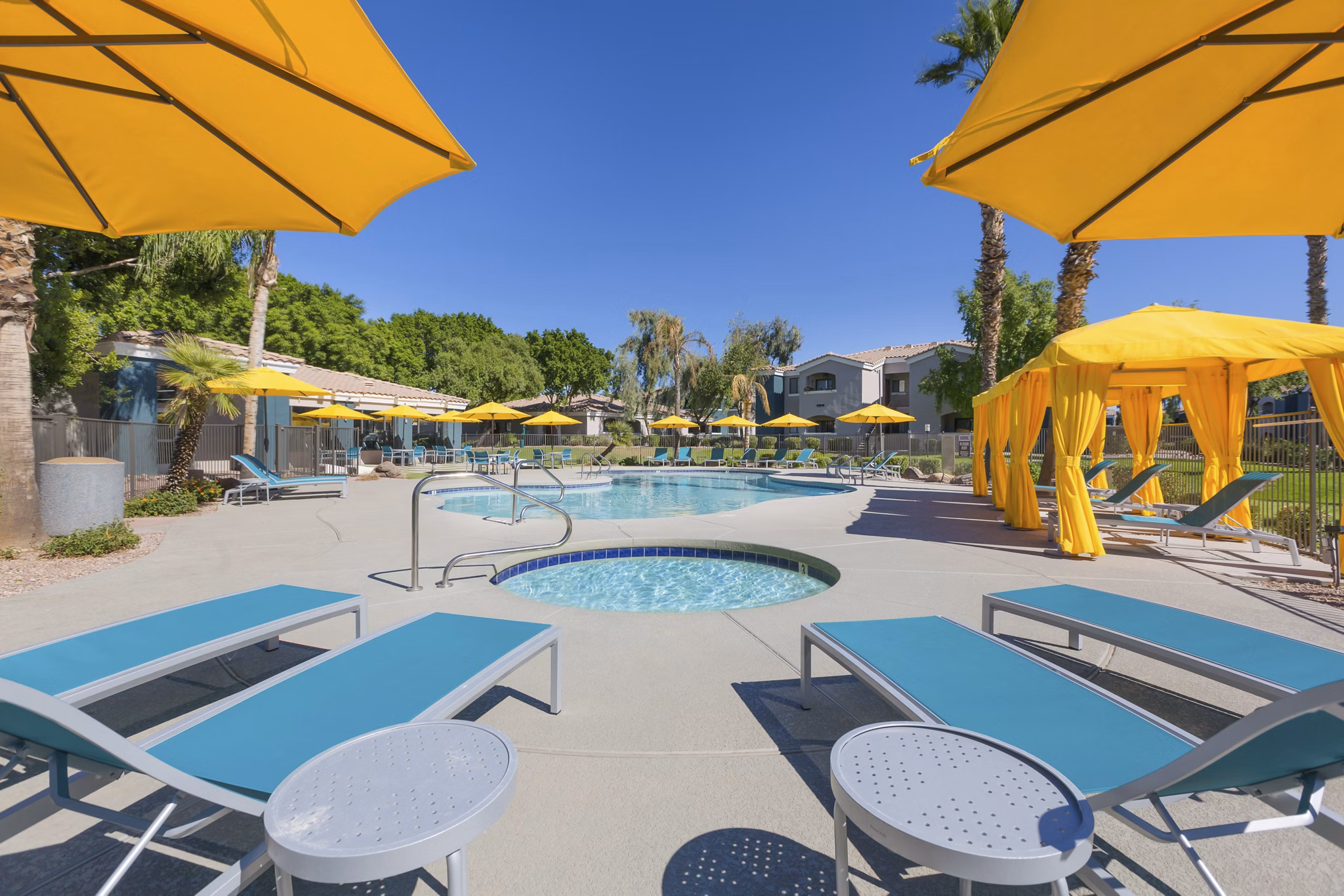 Inviting resort-style pool with sun loungers at Morada West Apartments for a luxurious living experience