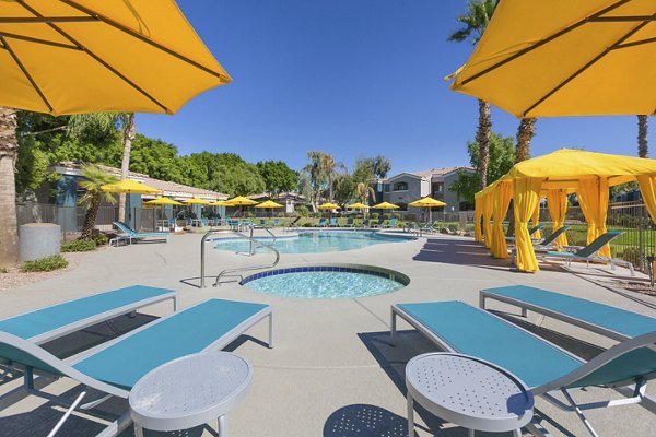 Inviting resort-style pool with sun loungers at Morada West Apartments for a luxurious living experience