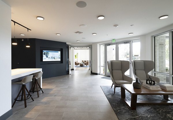 Gio Apartments: Modern clubhouse with elegant dÃ©cor and comfortable seating areas in the heart of our luxury apartment community