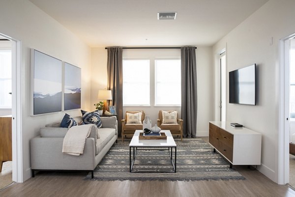 Stylish living room with modern furnishings at Gio Apartments, featuring a spacious layout ideal for relaxation and entertaining