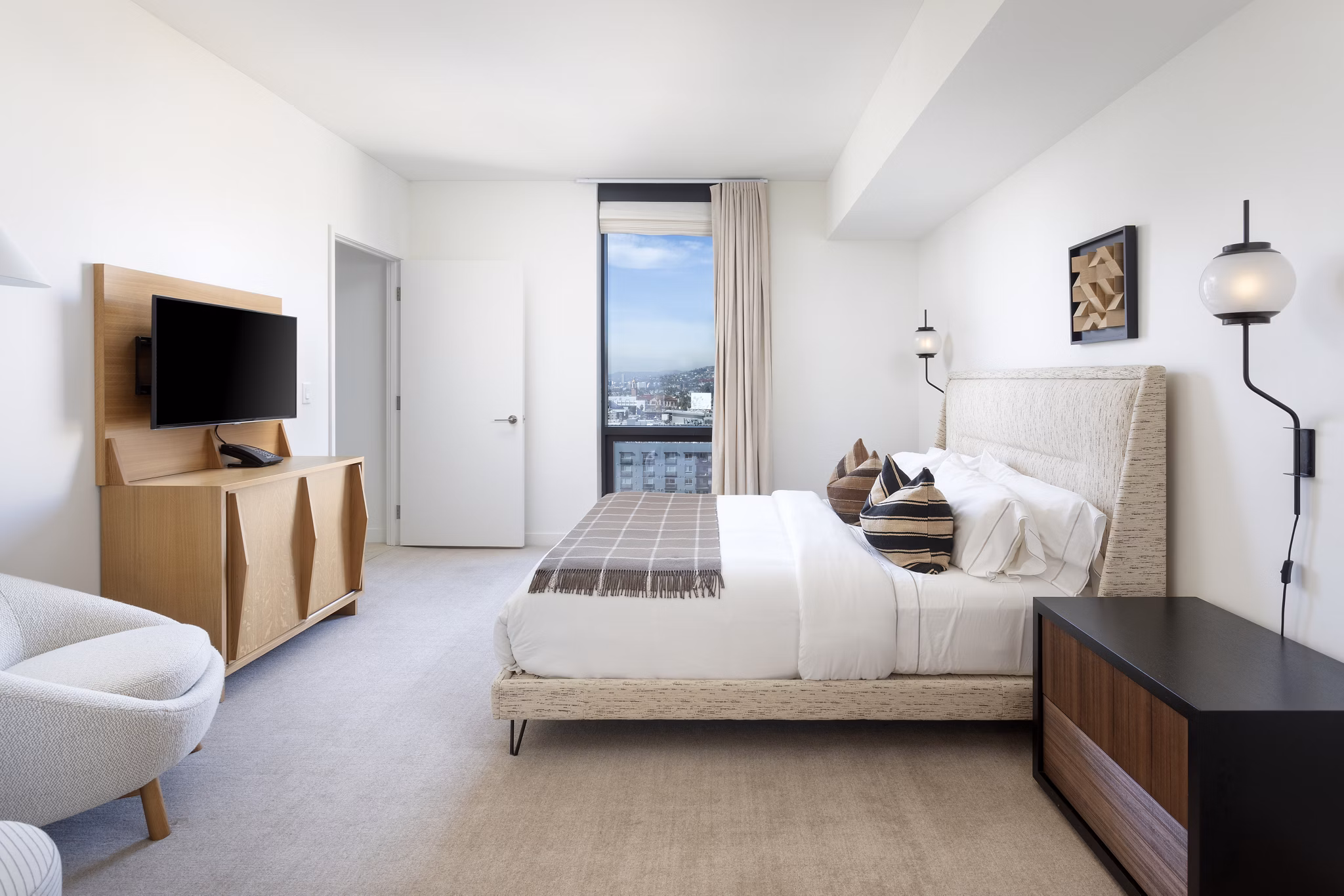 Spacious bedroom with modern decor and abundant natural light at Columbia Square Living Apartments
