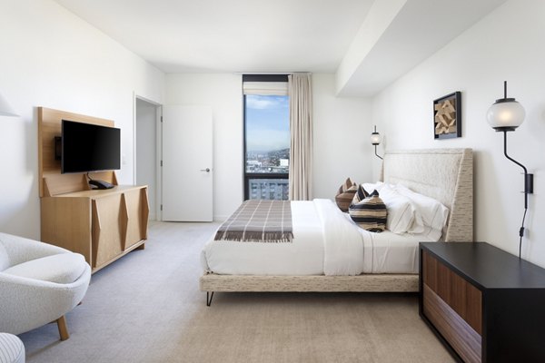 Spacious bedroom with modern decor and abundant natural light at Columbia Square Living Apartments