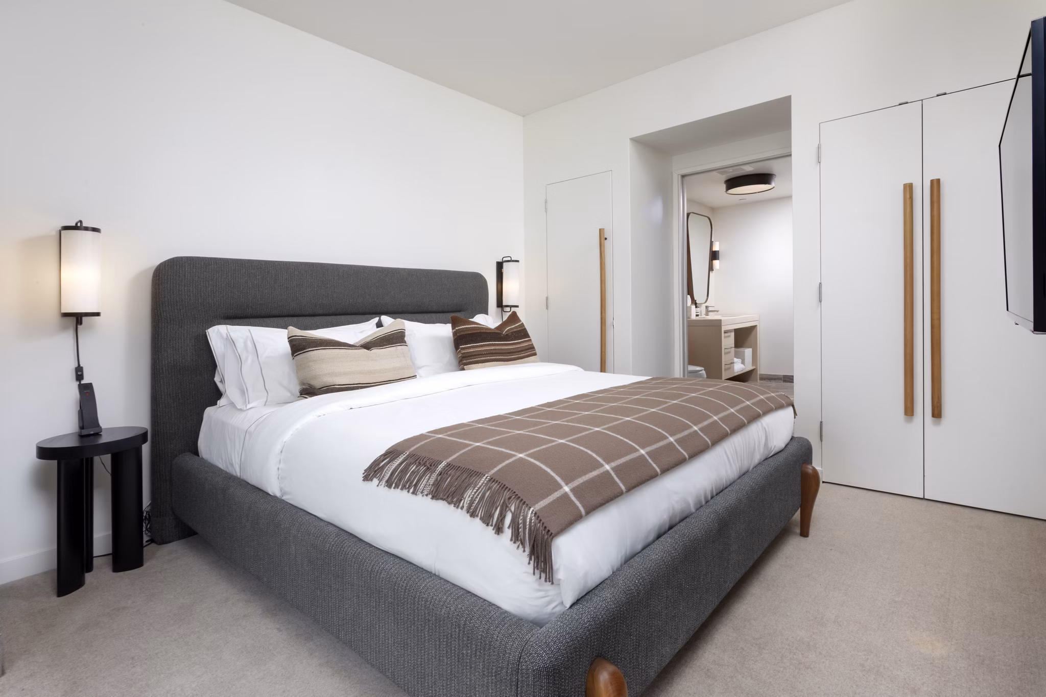 Bedroom featuring modern design and plush bedding at Columbia Square Living Apartments