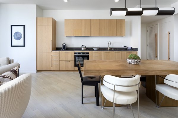 Modern kitchen with stainless steel appliances and granite countertops at Columbia Square Living Apartments