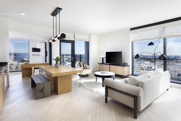 Living room featuring modern decor and large windows at Columbia Square Living Apartments