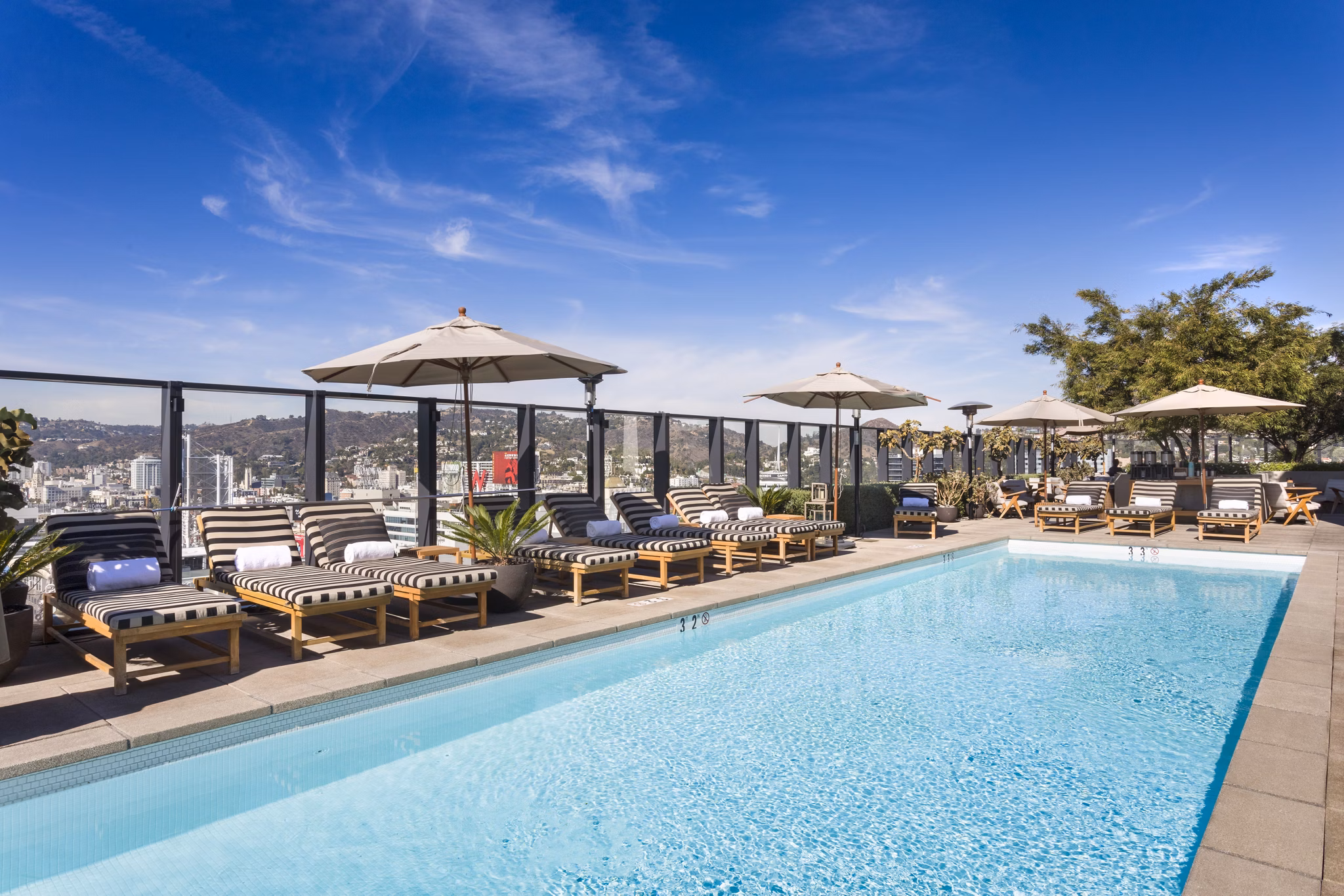 Pool with lounge chairs at Columbia Square Living Apartments, luxury community featuring resort-style amenities and modern design Perfect for relaxation and leisure