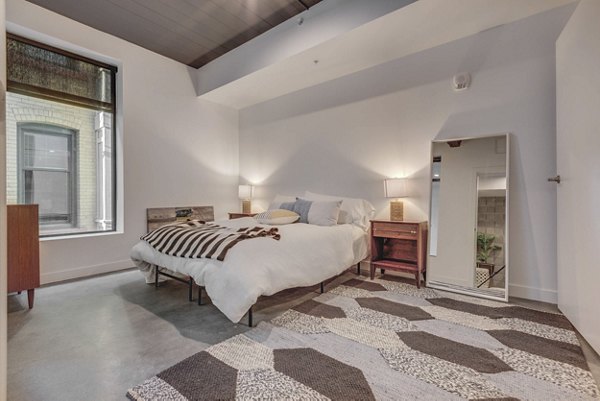 Cozy bedroom with modern furnishings at The Morton Apartments