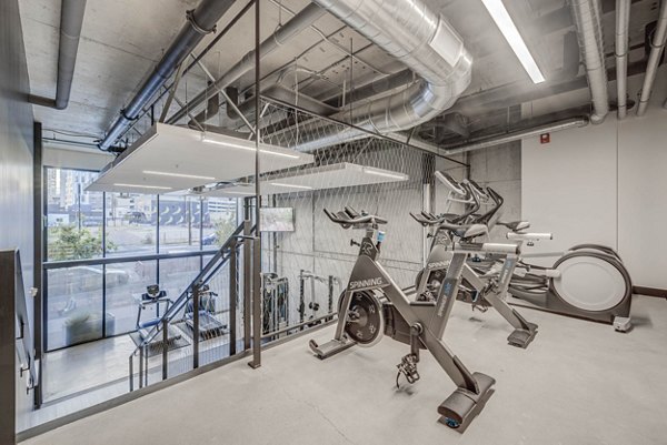 Fully-equipped fitness center at The Morton Apartments with modern gym infrastructure