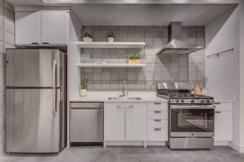 Modern kitchen with stainless steel appliances at The Morton Apartments