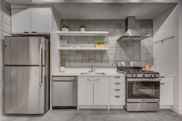 Modern kitchen with stainless steel appliances at The Morton Apartments