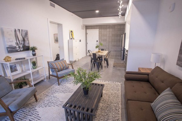 Modern living room with sleek furniture and natural light at The Morton Apartments