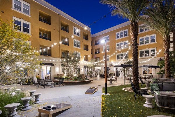 Chic courtyard with lush landscaping at Lex CTR City Apartments, a luxury Greystar community featuring modern outdoor seating