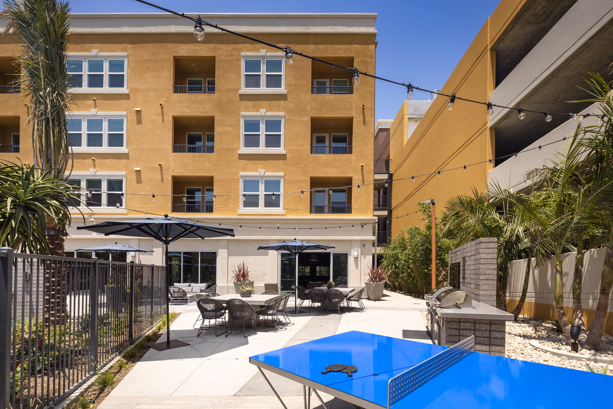 Tranquil courtyard with lush greenery at Lex CTR City Apartments, offering a peaceful retreat in the heart of luxury living