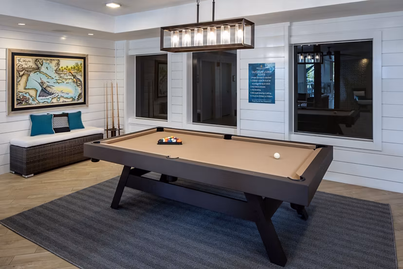 Vibrant game room with pool table and lounge seating at 1333 South Ocean Apartments