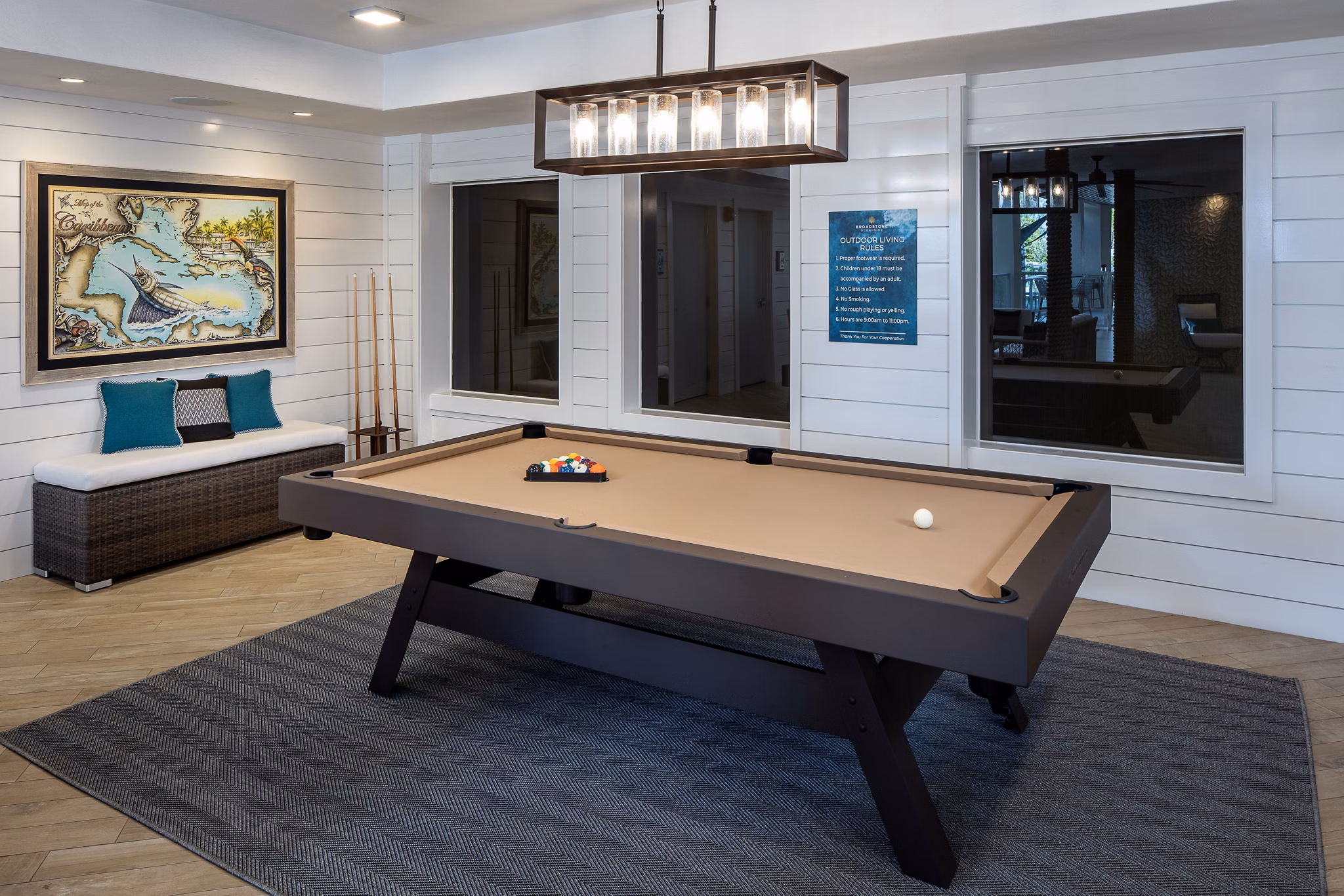 Vibrant game room with pool table and lounge seating at 1333 South Ocean Apartments