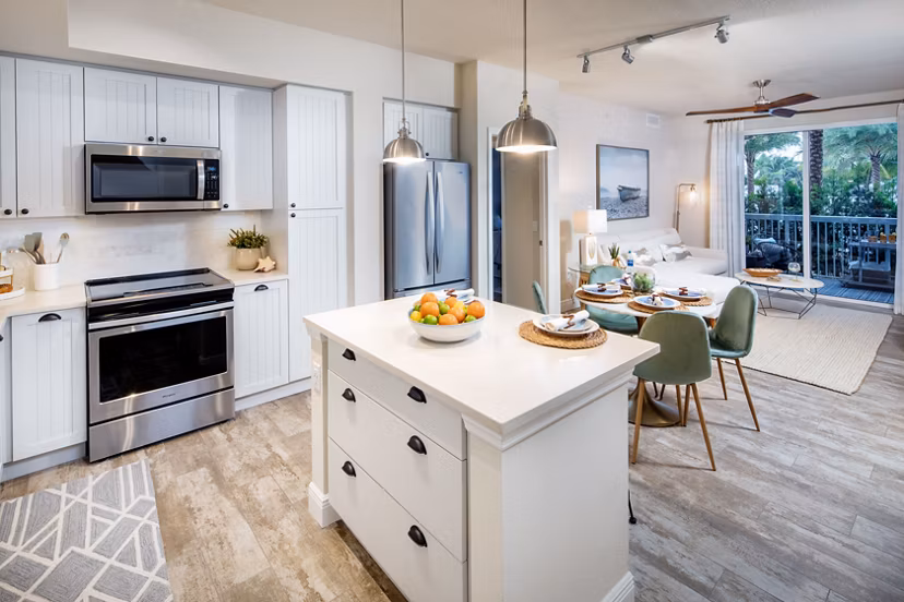 Modern kitchen with stainless steel appliances at South Ocean Apartments, luxury living near the coast