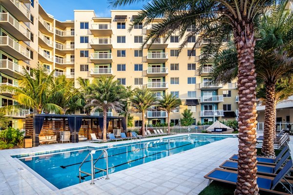 Oceanfront pool with palm trees at 1333 South Ocean Apartments, a luxurious escape in serene surroundings