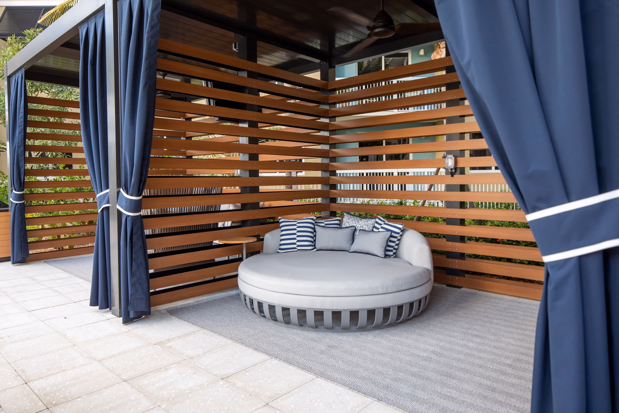 Large ocean-view patio at 1333 South Ocean Apartments, featuring comfortable seating and lush landscaping