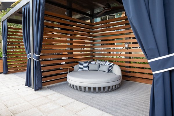 Large ocean-view patio at 1333 South Ocean Apartments, featuring comfortable seating and lush landscaping