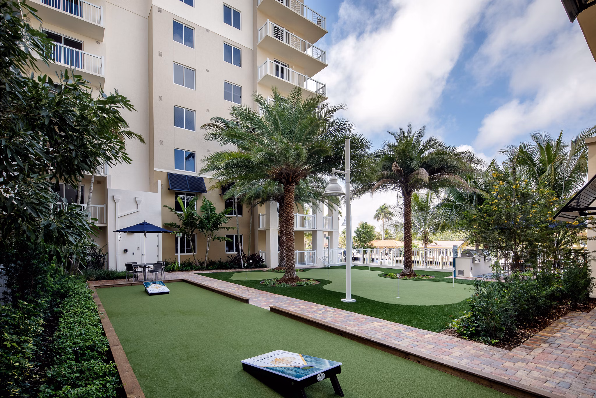 Tranquil courtyard with lush greenery and seating at 1333 South Ocean luxury apartments