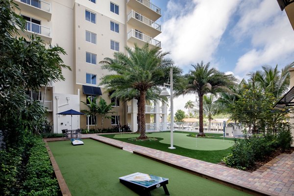 Tranquil courtyard with lush greenery and seating at 1333 South Ocean luxury apartments