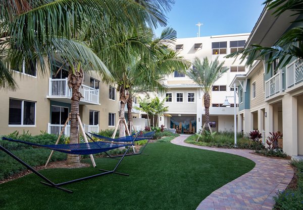 Charming courtyard with lush landscaping at 1333 South Ocean Apartments This tranquil outdoor space offers a peaceful retreat