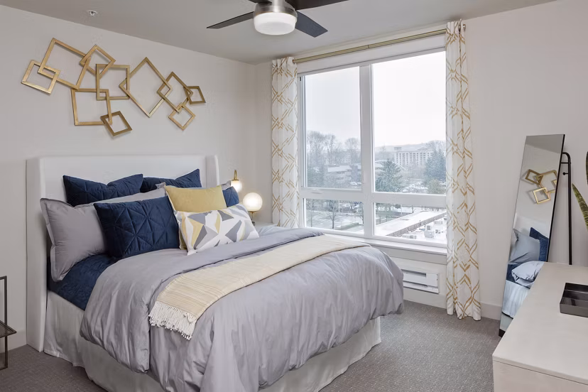 Cozy bedroom with plush bedding and natural light in Marvelle at Southcenter Apartments, luxury living spaces near Seattle