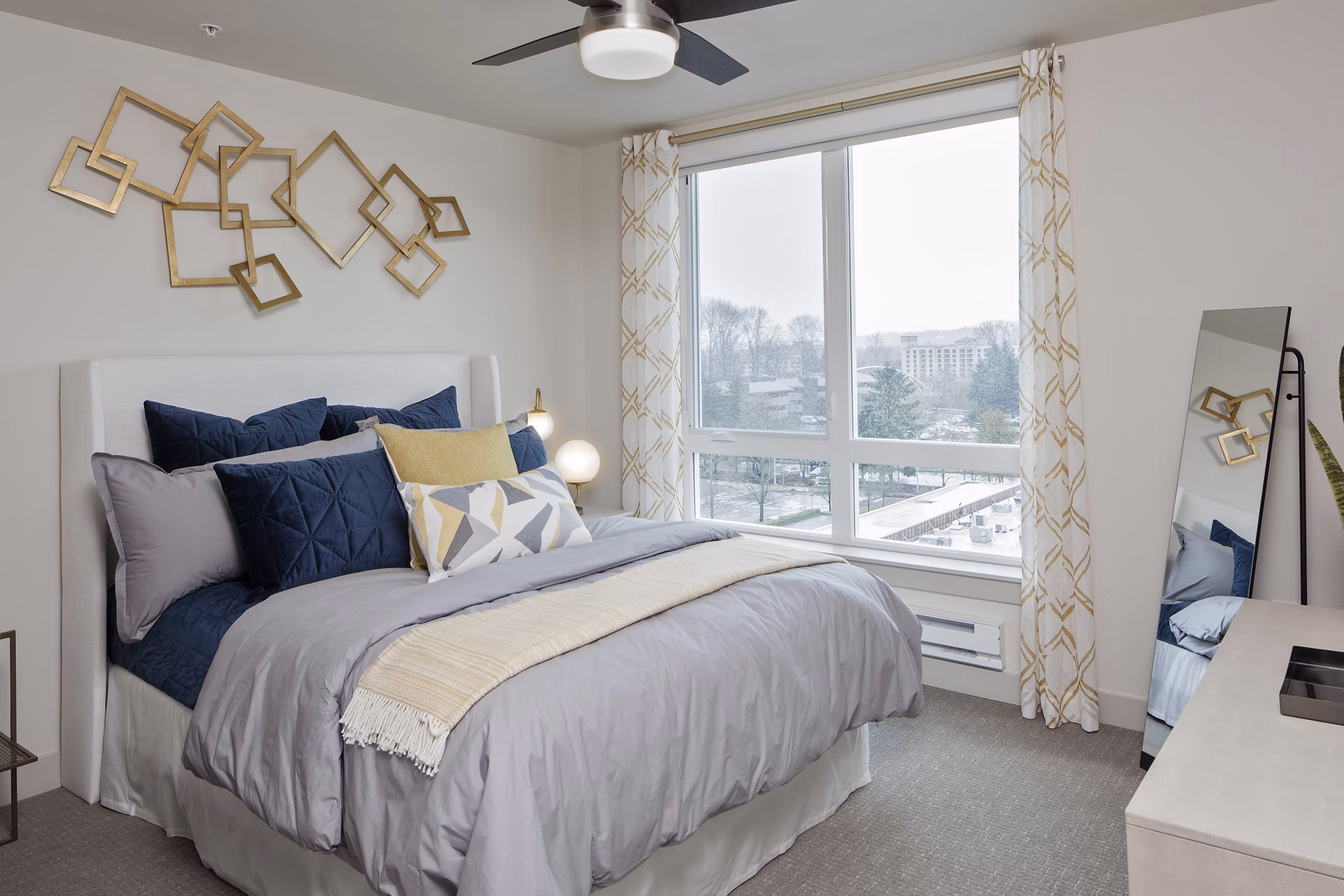 Cozy bedroom with plush bedding and natural light in Marvelle at Southcenter Apartments, luxury living spaces near Seattle