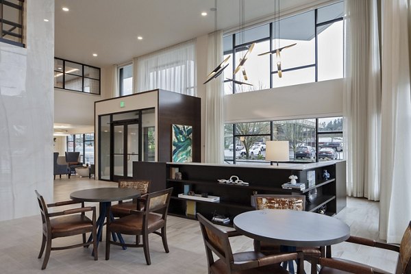 Modern clubhouse featuring spacious seating and entertainment areas at Marvelle at Southcenter Apartments