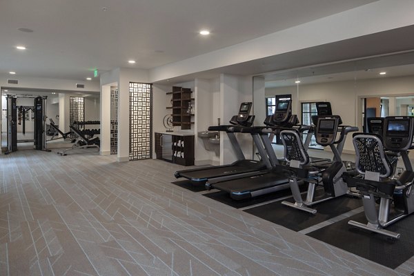 Modern fitness center with top-of-the-line equipment at Marvelle at Southcenter Apartments, offering a healthy lifestyle experience